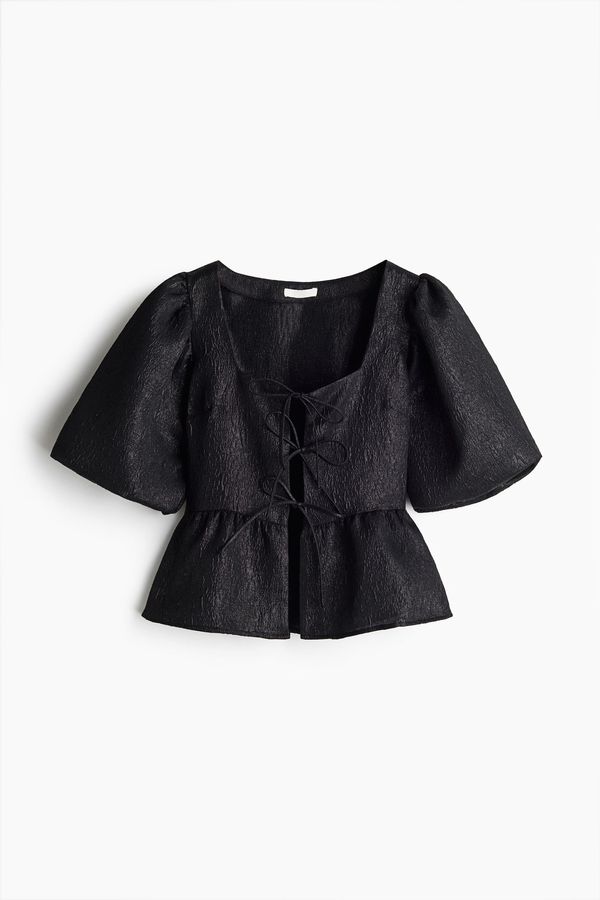 Blusa en tejido jacquard con lazadas
