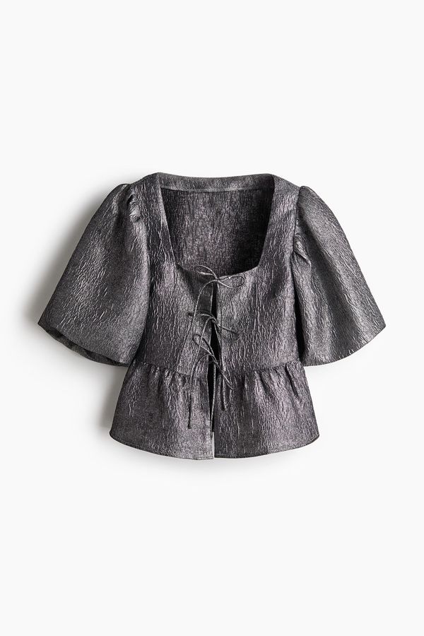 Blusa en tejido jacquard con lazadas